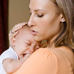 woman and holding a crying baby