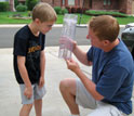 Photo of a father and son measuring rainfall data in Concord, N.C.