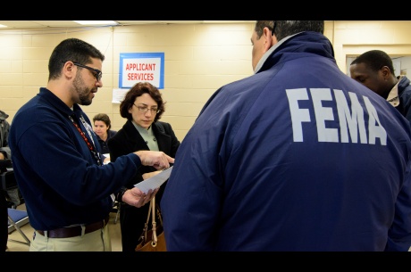 Officials visit a Disaster Recovery Center in Ft. Tilden