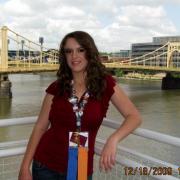 A young lady leaning on a railing.