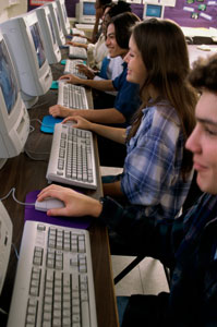 Photograph of young people taking a test using computers.