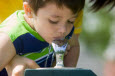 Little boy drinking water from fountain