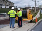 A KINBER construction crew prepares a spool of fiber for deployment