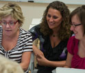 Photo of graduate research assistant Charity Cayton in center with teachers at workshop.
