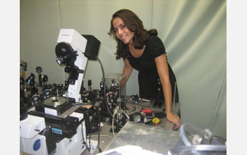 Photo of Markita Landry standing with a Total Internal Reflection Fluorescence Microscope.