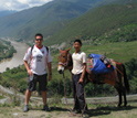 Photo of David Ortega and a man with a donkey at Tiger Leaping Gorge, Yunnan Province, China.