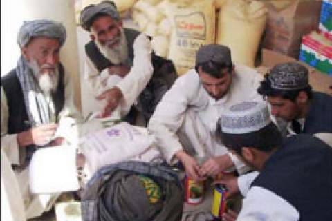 Afghan farmers cash in seed and fertilizer vouchers as part of a USAID-assisted poppy eradication program.