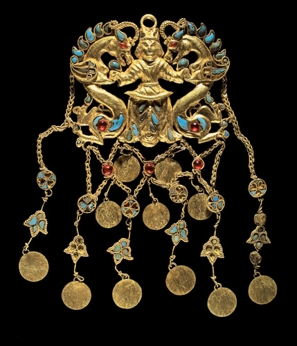 image: One of a pair of pendants showing the "Dragon Master," Tillya Tepe, Tomb II, Second quarter of the 1st century AD Gold, turquoise, garnet, lapis lazuli, carnelian and pearls National Museum of Afghanistan Photo © Thierry Ollivier/Musée Guimet