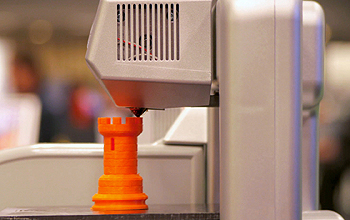 3-D printer prints a chess piece