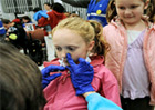 Little girl receiving nasal spray from school nurse