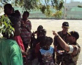 Captain Belardo and Commander Denis performing needs assessment with Haitian children.