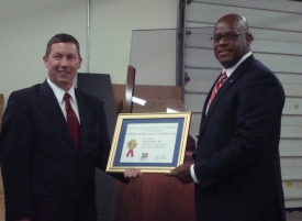 Photo of Maffei and Wade holding framed certificate