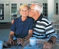 Photo of older man kissing woman