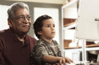 Photo of older man and child using computer