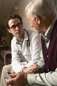 Photo of older man meeting with healthcare professional