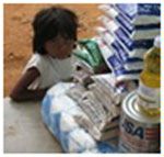 Date: 04/27/2011 Location: Rome, Italy Description: Little girl standing next to food supplies. © USUN Image