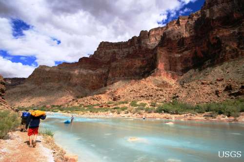 Scientists hike up the Little Colorado River to assist in installing remote PIT tag readers.