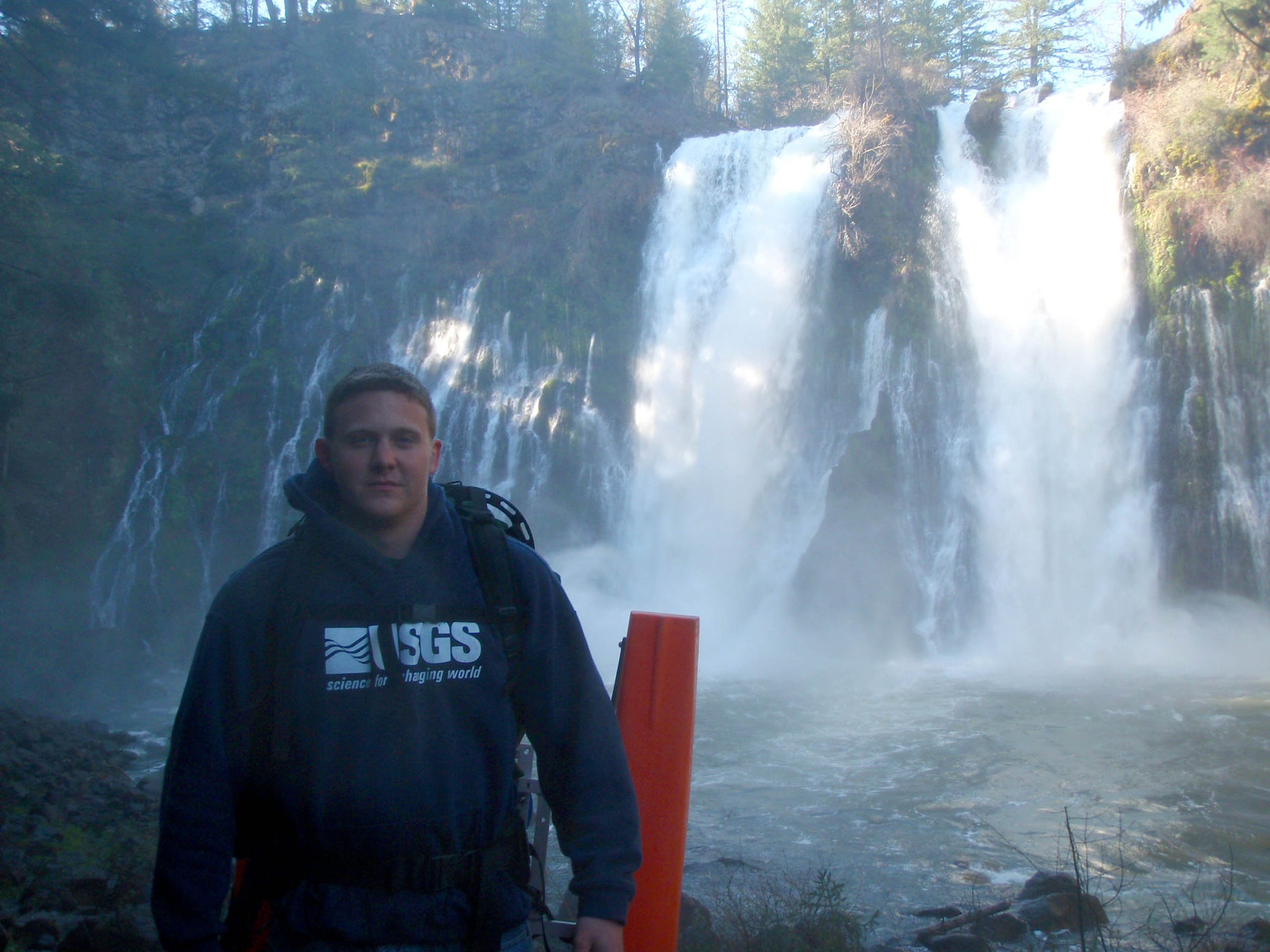 A picture of Josh Latimore standing in front of Burney Falls