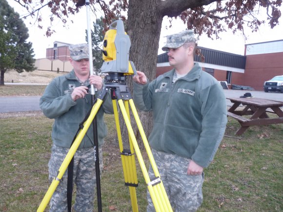 Missouri National Guard Spc. Brian Miller (left), and Spc. Derek Lenger, both members of Headquarters and Headquarters Company, 35th Engineer Brigade, test a surveying transit before they travel to Guantanamo Bay, Cuba, for their annual training.