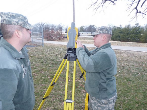 Missouri National Guard Spc. Brian Miller (left), and Spc. Derek Lenger, both members of Headquarters and Headquarters Company, 35th Engineer Brigade, test a surveying transit before they travel to Guantanamo Bay, Cuba, for their annual training.