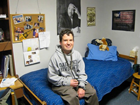 Self-advocate Micah Fialka-Feldman sitting in his dorm room