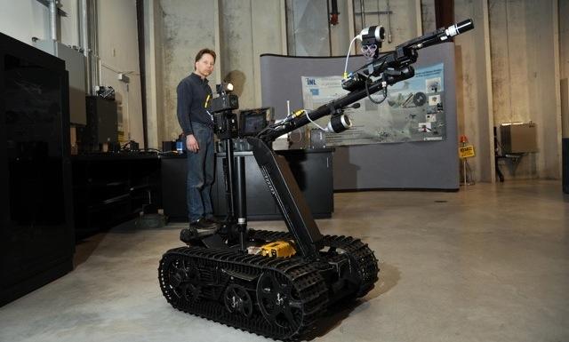 A technician at Idaho National Laboratory demonstrates the modified TALON robot.