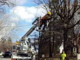 A KINBER construction crew strings fiber between telephone poles