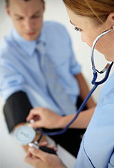 A nurse takes a man’s blood pressure