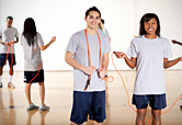 Teens jump rope during gym class.