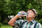 A man drinks a bottle of water.