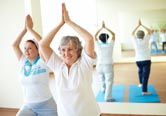 Two women do yoga together.