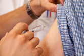 A man receives a vaccine before he travels internationally.