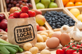 Fresh fruits and vegetables lined up at the grocery store.