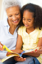 A mother reads with her daughter.