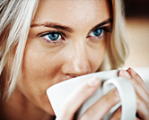 Women takes a sip of coffee.