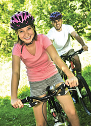 Image of a teenage girl biking with her dad