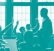 image of students raising hands and teacher
