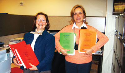 Research Nurses Sharon Mavroukakis (left) and Cindy Delbrook (right) display the documentation on WT-1 immunotherapy submitted to the Food and Drug Administration for the Investigational New Drug application.