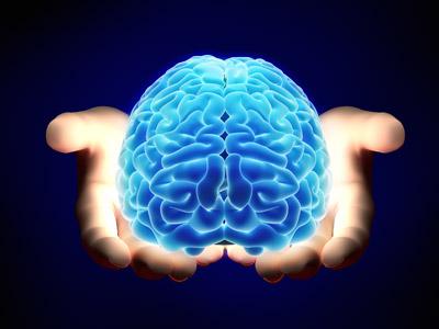 Hands holding a glowing brain 