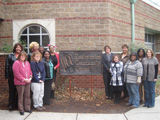 Thirteen female champions from Louisville stand outside of the Presbyterian Community Center.