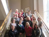 Sixteen men and women are photographed on a staircase in Madison, Wisconsin.