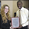 A girl and man holding an award