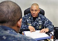 Master Chief Navy Counselor Paul A. Tyquiengco counsels a Sailor assigned to the Nimitz-class aircraft carrier USS Abraham Lincoln (CVN 72).