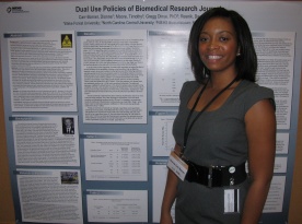 2010 intern Dionne Barner standing in front a research project poster