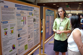 Intern Northup standing in front of her poster during the Summers of Discovery Poster Session