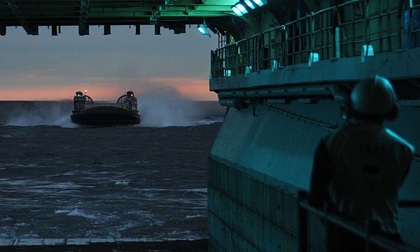 A landing craft air cushion from Assault Craft Unit (ACU) 4 approaches the well deck of the multipurpose amphibious assault ship USS Bataan (LHD 5). Bataan is underway conducting routine qualifications in support of amphibious assault squadron and marine expeditionary unit integrated training.  U.S. Navy photo by Mass Communication Specialist Seaman Mark Hays (Released)  130926-N-JX484-114