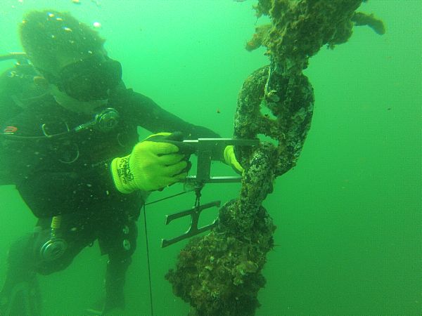 Builder 2nd Class Matthew Dawson, from Chicago, assigned to Underwater Construction Team (UCT) 2, inspects a fleet mooring riser chain for wear at Joint Base Pearl Harbor-Hickam. Seabee divers from UCT-2's Construction Dive Detachment Bravo are inspecting and repairing more than 100 fleet mooring buoys during their second of three stops across the Pacific during a six-month deployment.  U.S. Navy photo by Steel Worker 2nd Class Metro Sayre (Released)  130926-N-ZZ999-001