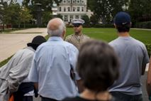 Cpl. Mondo Lescaud, combat correspandant from Marine Barracks Washington, D.C., gives a tour of the Barracks during the Barracks Row Fall Festival on 8th St. SE, Washington, D.C., Sept. 28.