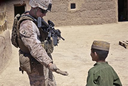 U.S. Marine Corps 1st Lt. Michael Smith interacts with an Afghan boy in Barrmo in the Washir district of Afghanistan, Sept. 19, 2013. Smith is assigned to the 33rd Georgian Liaison Team. 