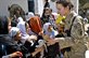 U.S. Army Capt. Jennifer Leathers gives donated stuffed animals to Afghan orphans during a meeting with leaders to inspect a solar power project, and deliver toys, books and health supplies to children at the Farah Orphanage in Farah City, Afghanistan, Sept. 26, 2013. The team's mission is to train, advise and assist Afghan government leaders at the municipal, district and provincial levels in the province. U.S. Navy photo by Lt. Chad A. Dulac